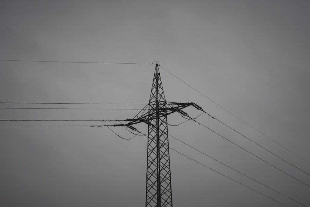 black electric post under gray sky